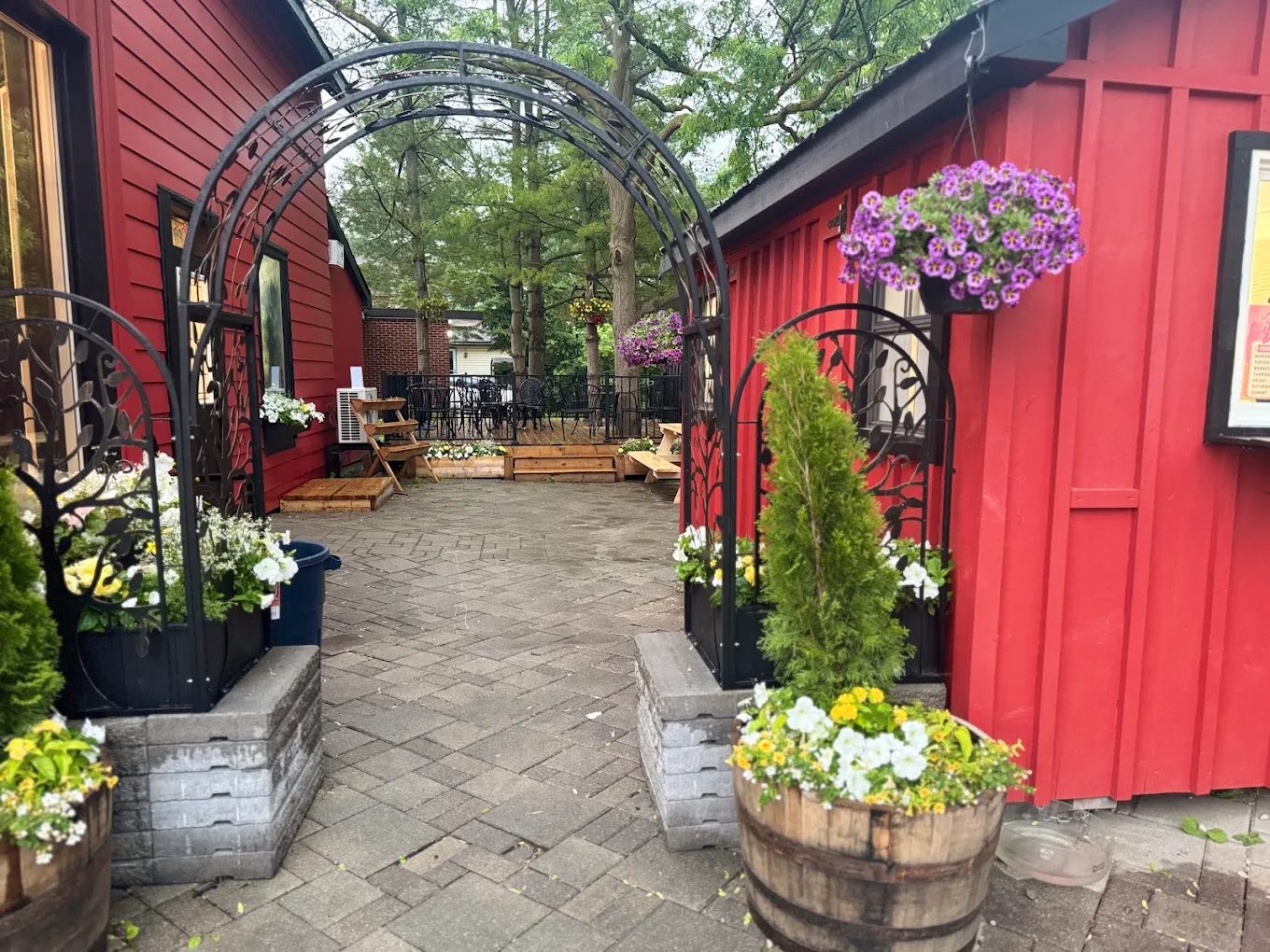 The courtyard patio with its iron arch and flower barrels.