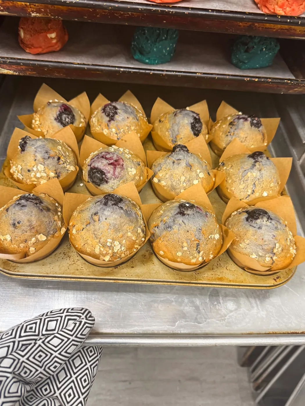 A tray of fresh-baked streusel-topped muffins from The OG 1870 bakery.