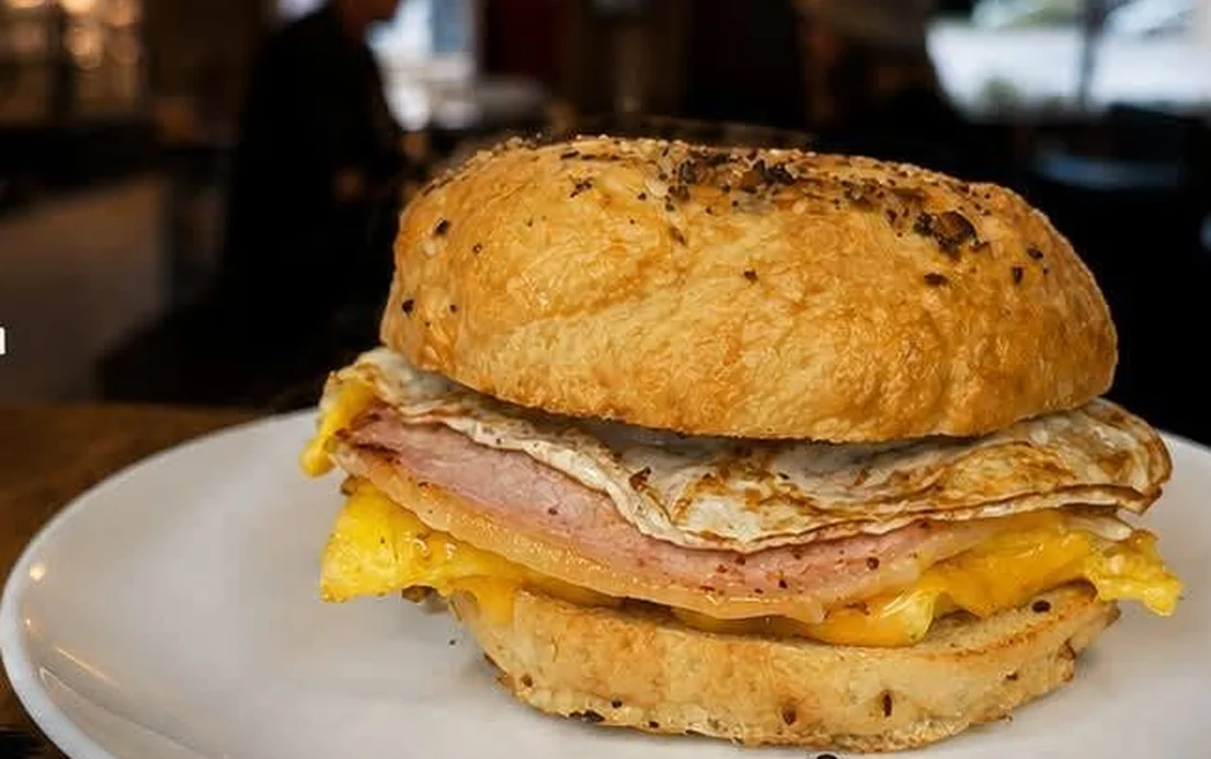 A Grab & Go breakfast bagel — ham, a freshly cooked egg and melted cheddar on a house-baked bagel.